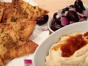 pita chips with humus and Boukovo chili oil