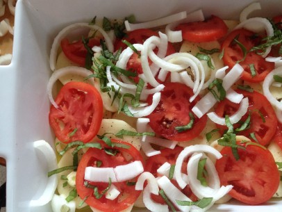 coat pan with olive oil and add first layer of potatoes, tomatoes, basil